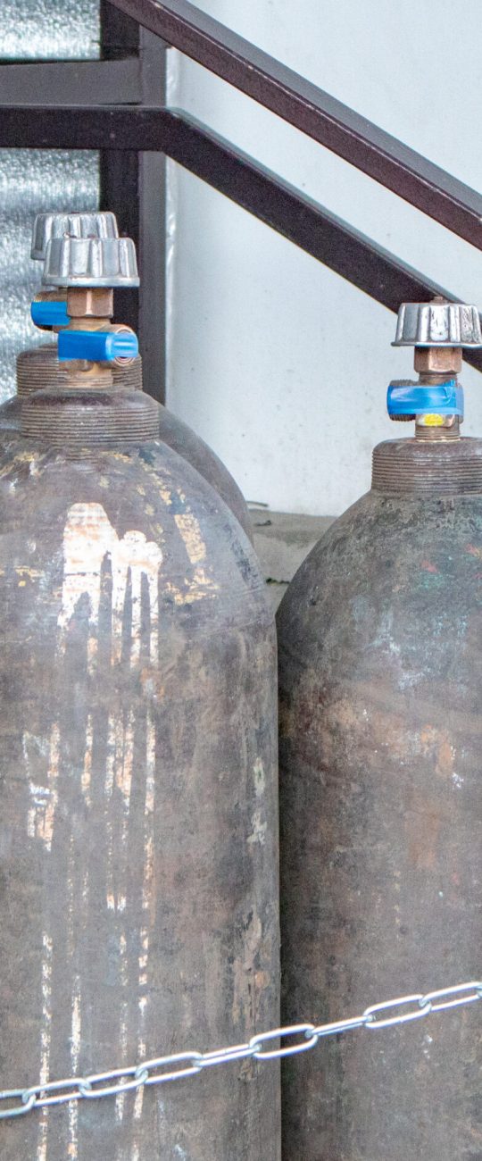 Close-up of steel cylinders with compressed gas - argon, carbon dioxide or oxygen for welding, outdoors.